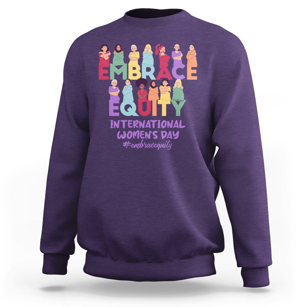 Purple crewneck sweatshirt with colorful “EMBRACE EQUITY” women’s day graphic on back