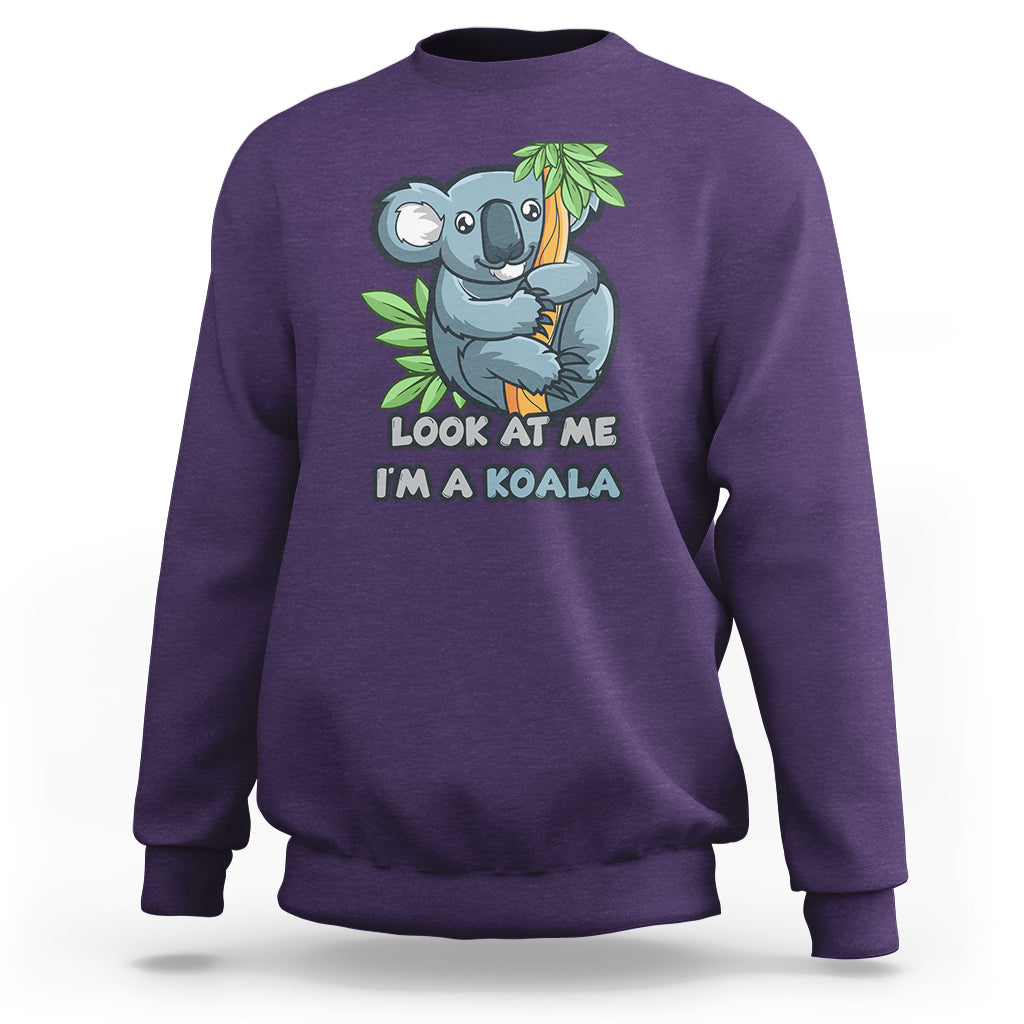 Purple crewneck sweatshirt with koala graphic and 'LOOK AT ME I'M A KOALA' text
