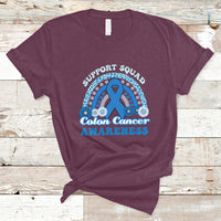 Maroon t-shirt with Support Squad Colon Cancer Awareness text and blue awareness ribbon graphic.