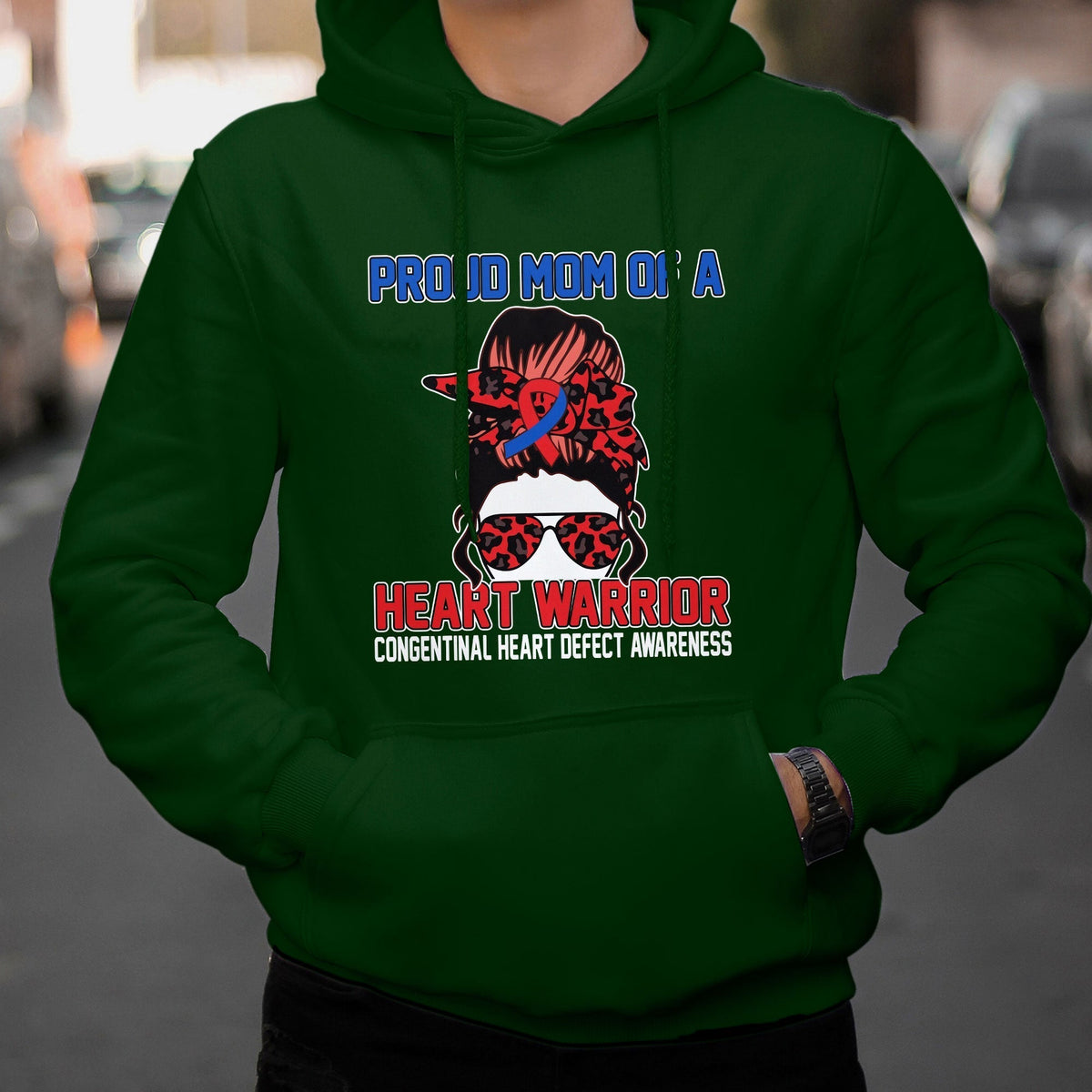 Green hoodie with “Heart Warrior” heart-defect awareness graphic on the chest
