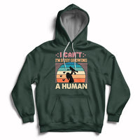 Forest green maternity pullover hoodie with kangaroo pocket and drawstring hood; busy human graphic