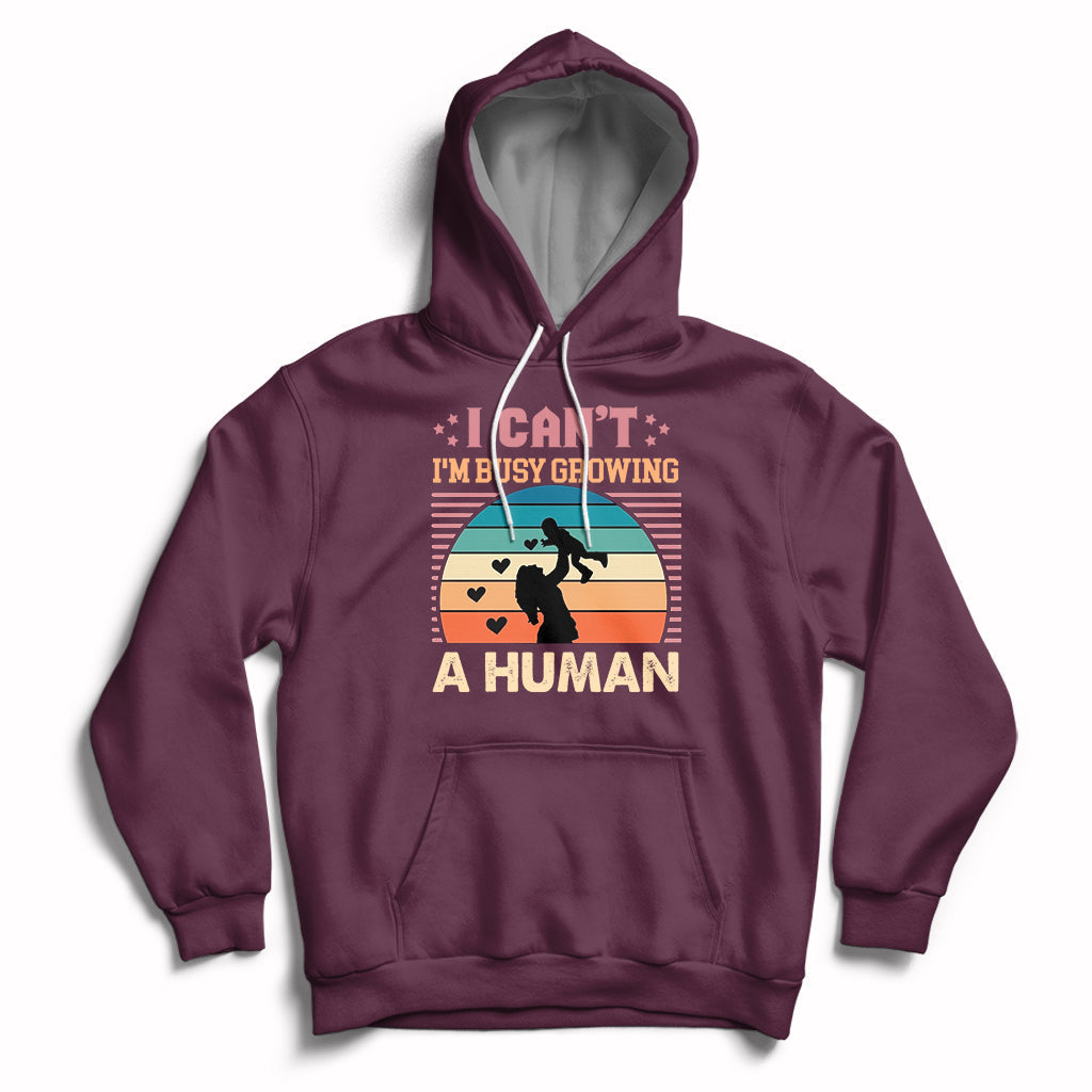 Maroon maternity pullover hoodie with kangaroo pocket and drawstring hood; busy human graphic