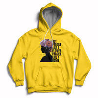 Women's daisy yellow pullover hoodie with front pocket and floral silhouette graphic.