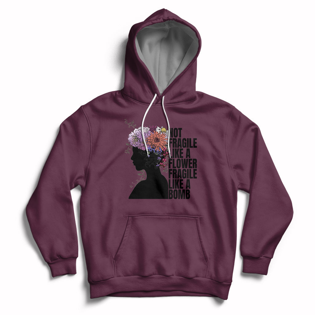 Women's maroon pullover hoodie with front pocket and floral silhouette graphic on chest.