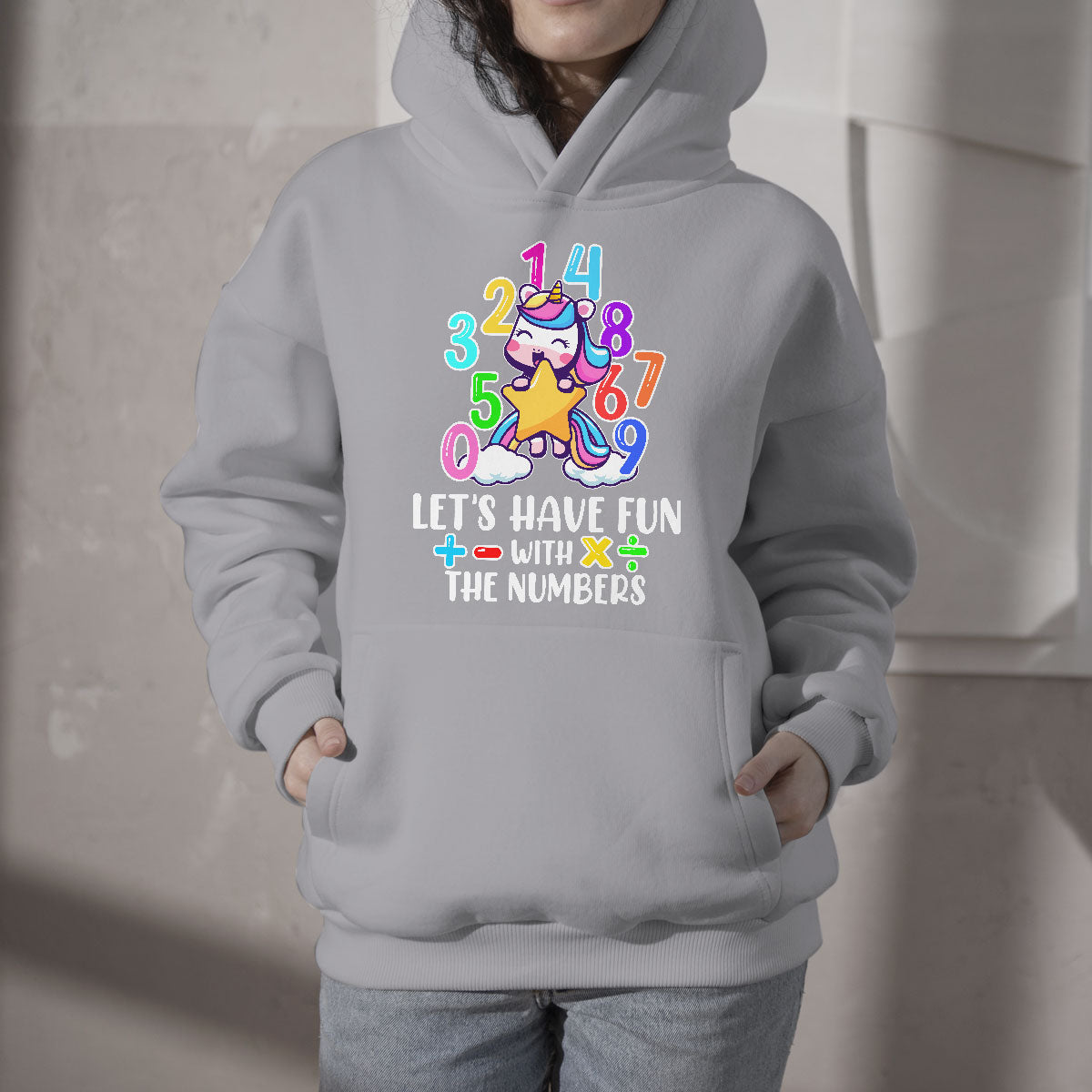Light gray kids hoodie with colorful unicorn number graphic and slogan on the front