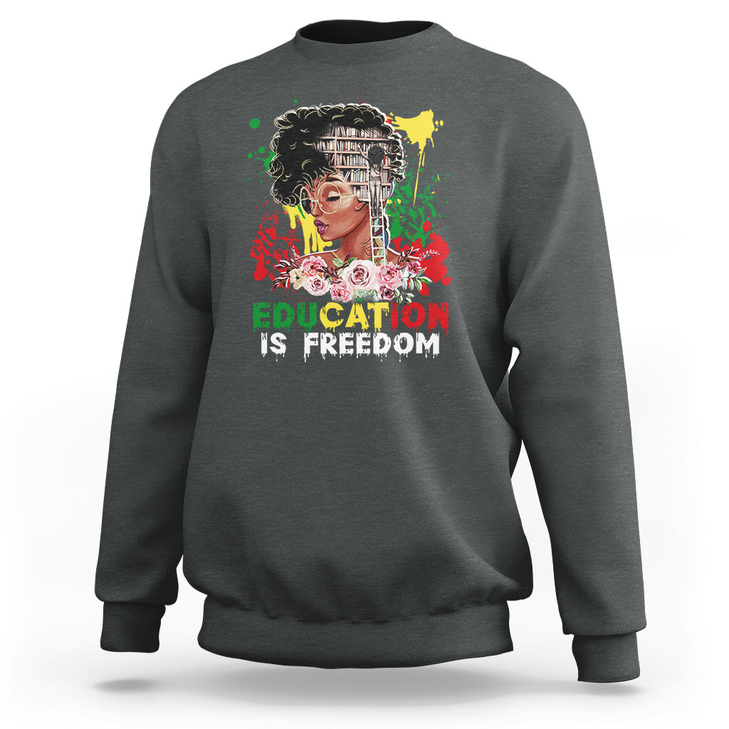 Adult crewneck sweatshirt, dark heather gray, front graphic with face and “Education is Freedom”.