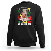 Adult crewneck sweatshirt, black, front graphic with face and text “Education is Freedom”.