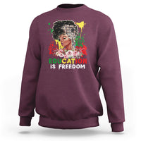 Adult crewneck sweatshirt, maroon, front graphic with face and “Education is Freedom”.