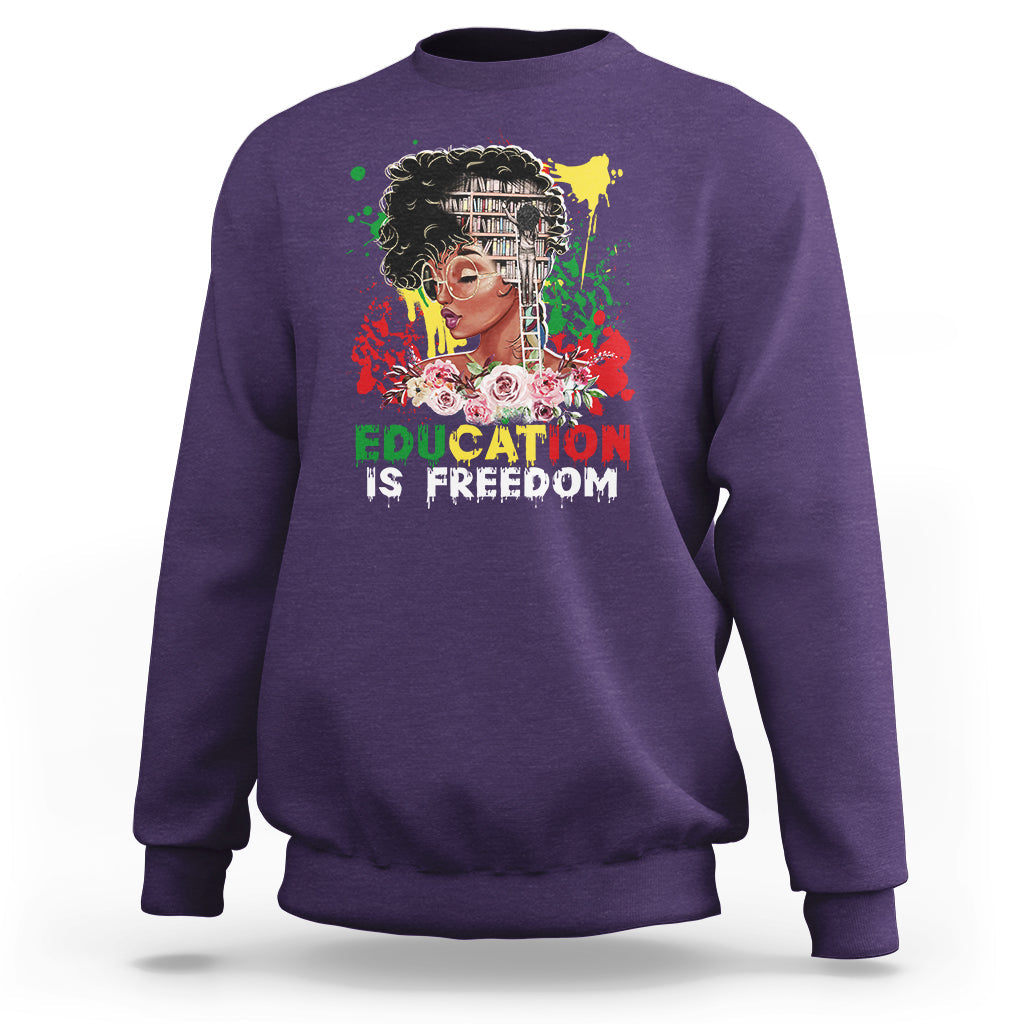 Adult crewneck sweatshirt, purple, front graphic with face and “Education is Freedom”.