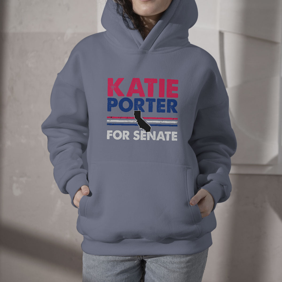 Slate blue hoodie with hood, front pouch, and "KATIE PORTER FOR SENATE" graphic