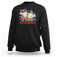 Women's black sweatshirt with colorful butterfly and “Be Bold for Change” graphic on front