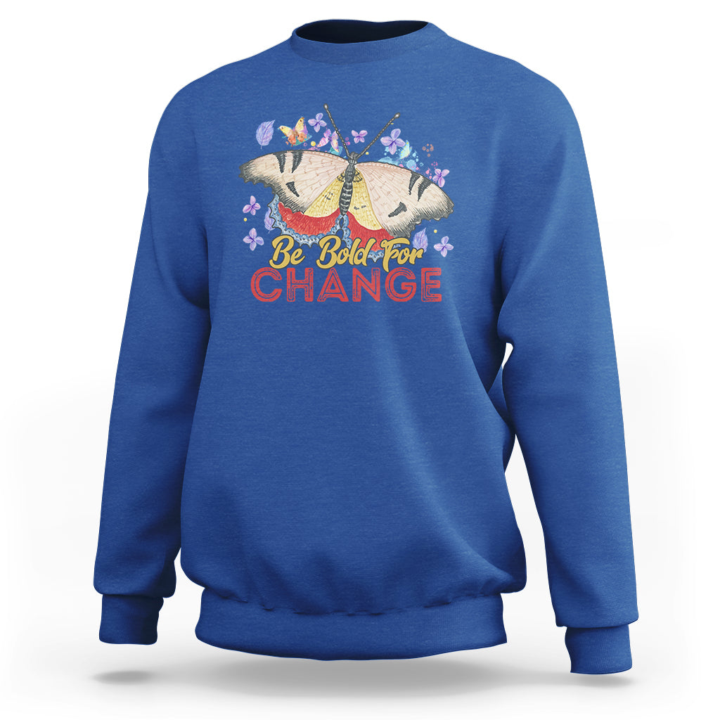 Women's royal blue sweatshirt with colorful butterfly and “Be Bold for Change” graphic