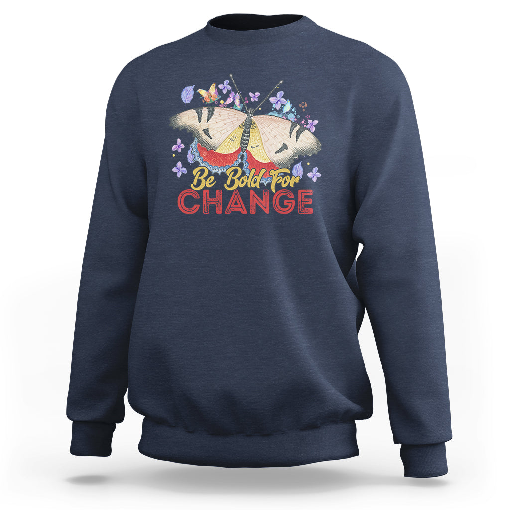Women's navy sweatshirt with colorful butterfly and “Be Bold for Change” graphic on front
