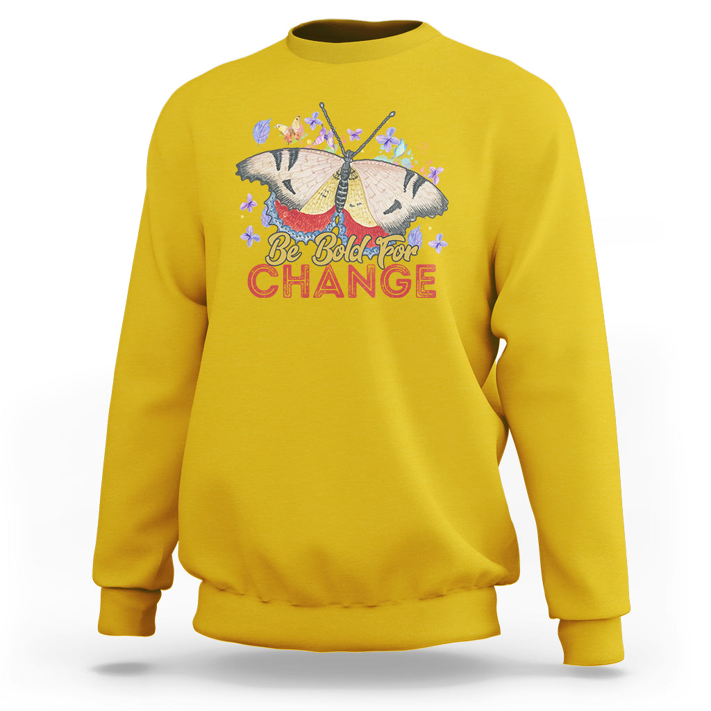 Women's daisy yellow sweatshirt with colorful butterfly and “Be Bold for Change” graphic