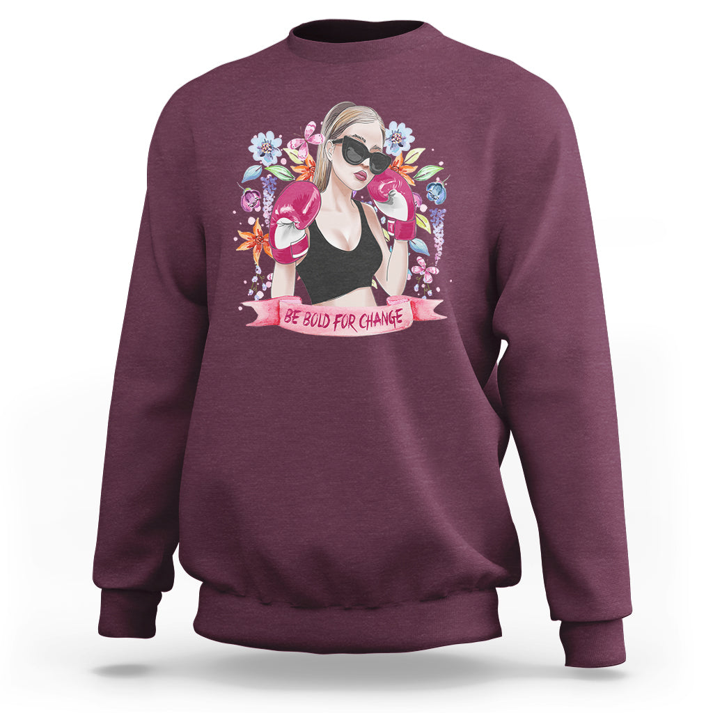 Women’s maroon graphic sweatshirt with illustrated girl portrait and floral “Be Bold for Change”