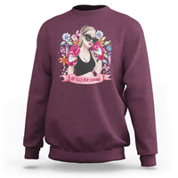 Women’s maroon graphic sweatshirt with illustrated girl portrait and floral “Be Bold for Change”