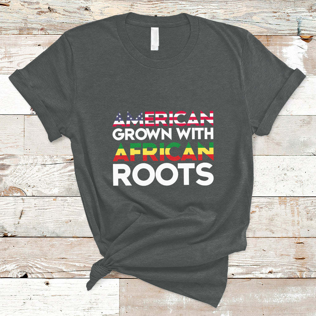 Dark gray crew-neck T-shirt with “AMERICAN GROWN WITH AFRICAN ROOTS” front print