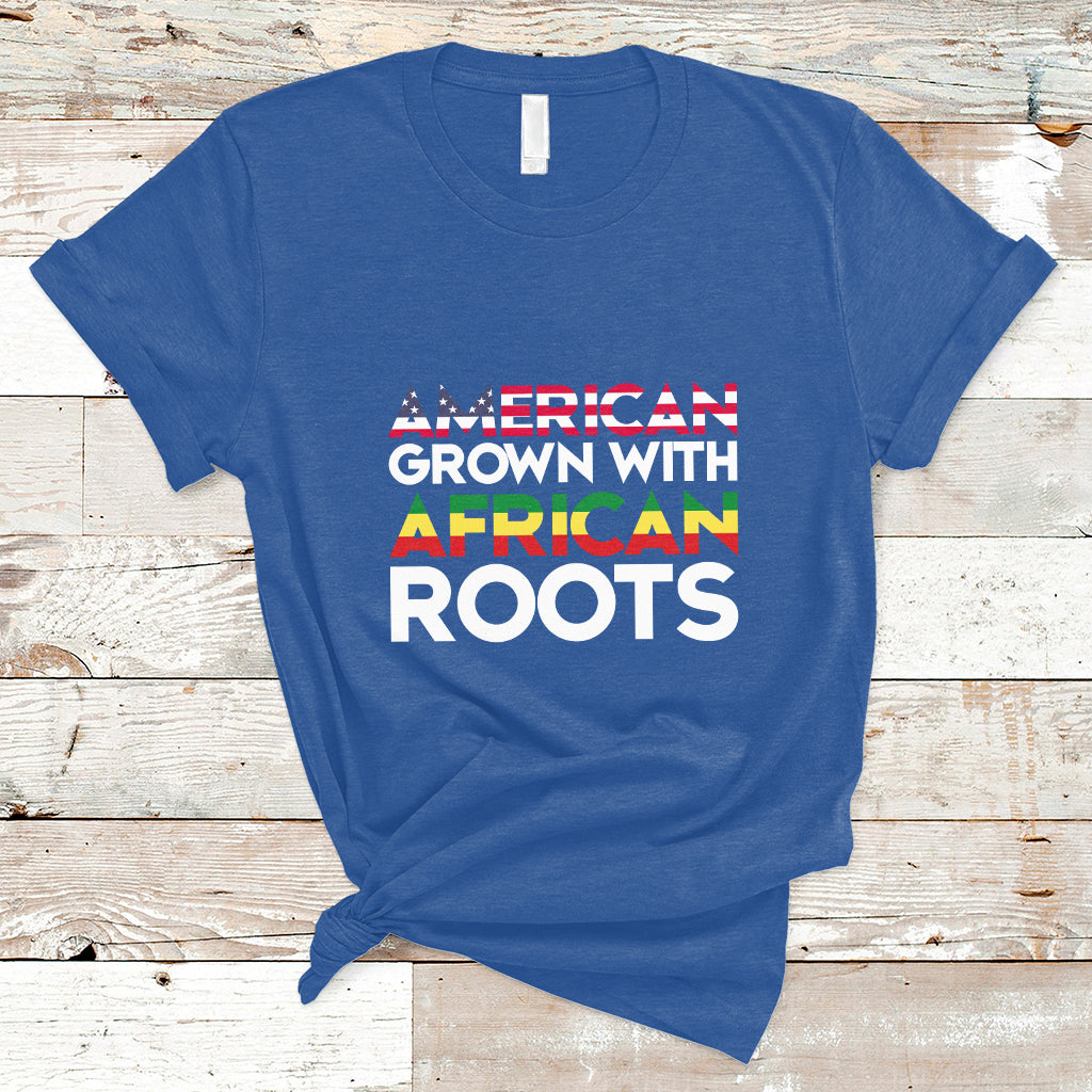 Royal blue crew-neck T-shirt with “AMERICAN GROWN WITH AFRICAN ROOTS” front print