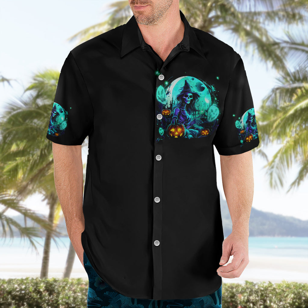 Black Hawaiian shirt, front view on model with teal skull witch pocket-height graphic