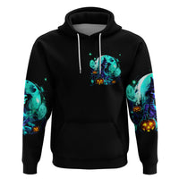 Black pullover hoodie with teal witch skull graphic on the chest and bright sleeve prints