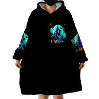 Black wearable blanket hoodie blanket-length with teal witch skull graphic at chest