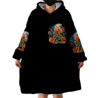 Black wearable blanket hoodie with hood; chest pumpkin-skull graphic, full front view