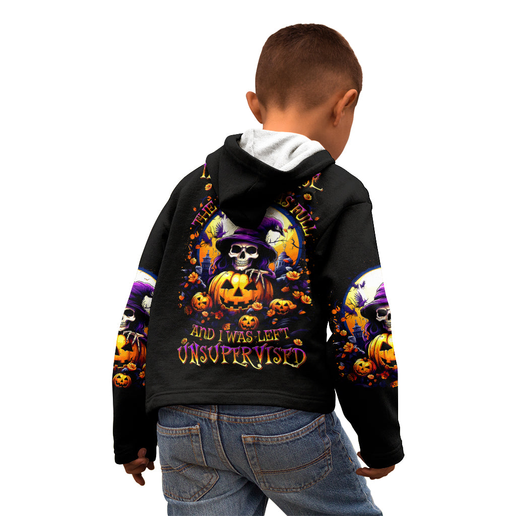 Black hoodie on child with skull-and-pumpkin graphic on the back and sleeves