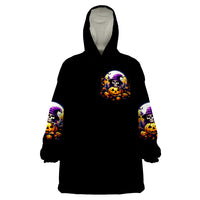 Black wearable blanket hoodie with skull and pumpkin graphic on chest, wide sleeves.