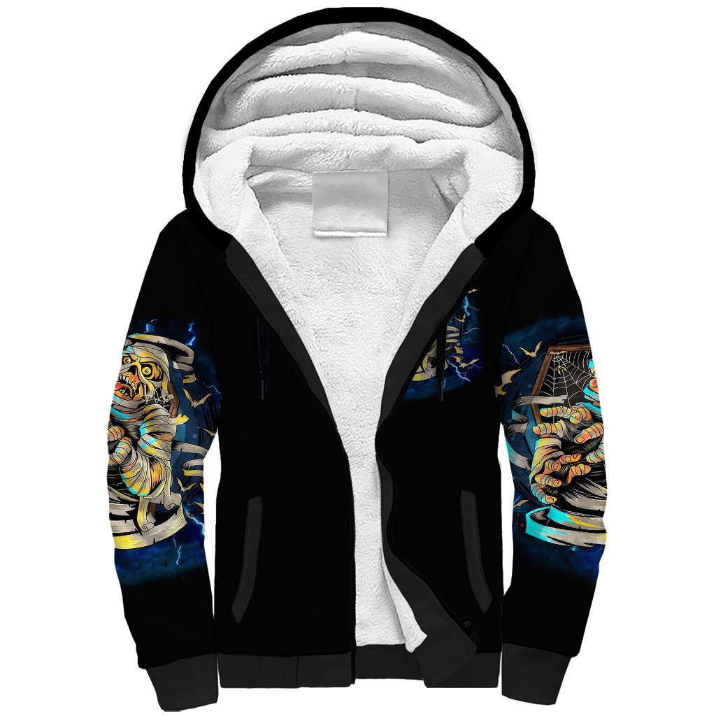 Black sherpa hoodie with white fleece-lined hood and colorful sleeve skull prints