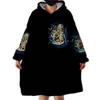 Black wearable blanket hoodie with hood and skull graphic; long sleeves with printed cuffs