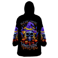 Black hooded wearable blanket hoodie with colorful skull and witch-face graphic