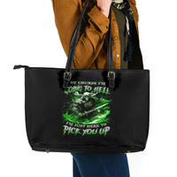 Black leather-look tote bag with green skull graphic and long double handles.