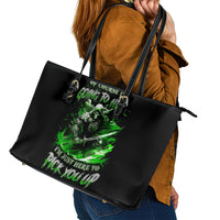 Black tote bag with green skull graphic and top edge zipper trim, angled view.