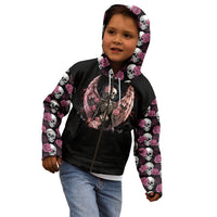 Child wearing black hoodie with hood up, angel skull front graphic, pink rose-and-skull sleeves.