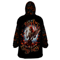 Black wearable blanket hoodie with hood, featuring Next Life karma fairy skeleton print