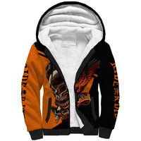 Black and orange sherpa hoodie with skull wings graphic; white sherpa-lined hood