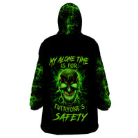 Black hooded wearable blanket hoodie with neon green skull graphic on front.