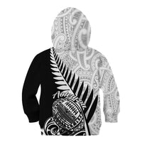 Kids’ black rugby hoodie with grey patterned sleeves, hood and fern graphic