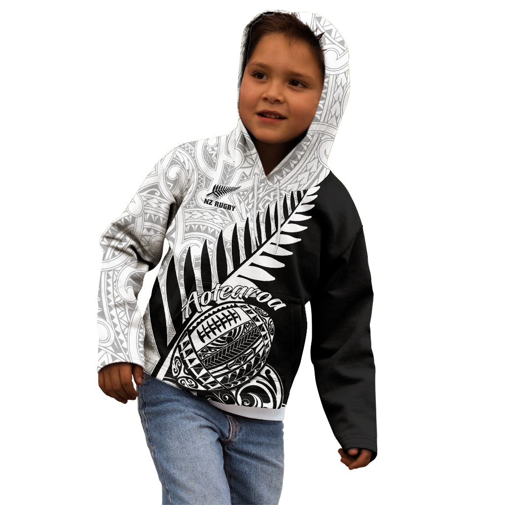 Kids’ black and white rugby hoodie with patterned hood and large fern shield graphic