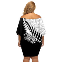 Women’s off-shoulder short dress back view, black with large fern and tribal print