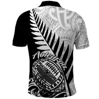 Black rugby polo shirt, back view with large fern leaf and Maori-style artwork