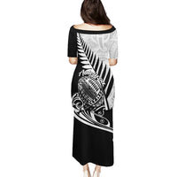 Black rugby pulletasi long dress with silver fern tribal print and Aotearoa text, back view