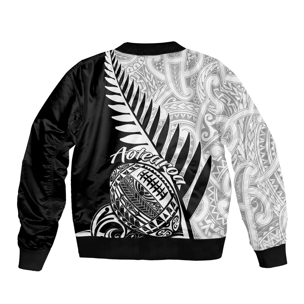 Black bomber jacket with ribbed collar and large Aotearoa tribal graphic on back