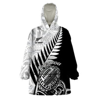 Wearable blanket hoodie with black-and-white Maori tribal print, hood and pouch pocket