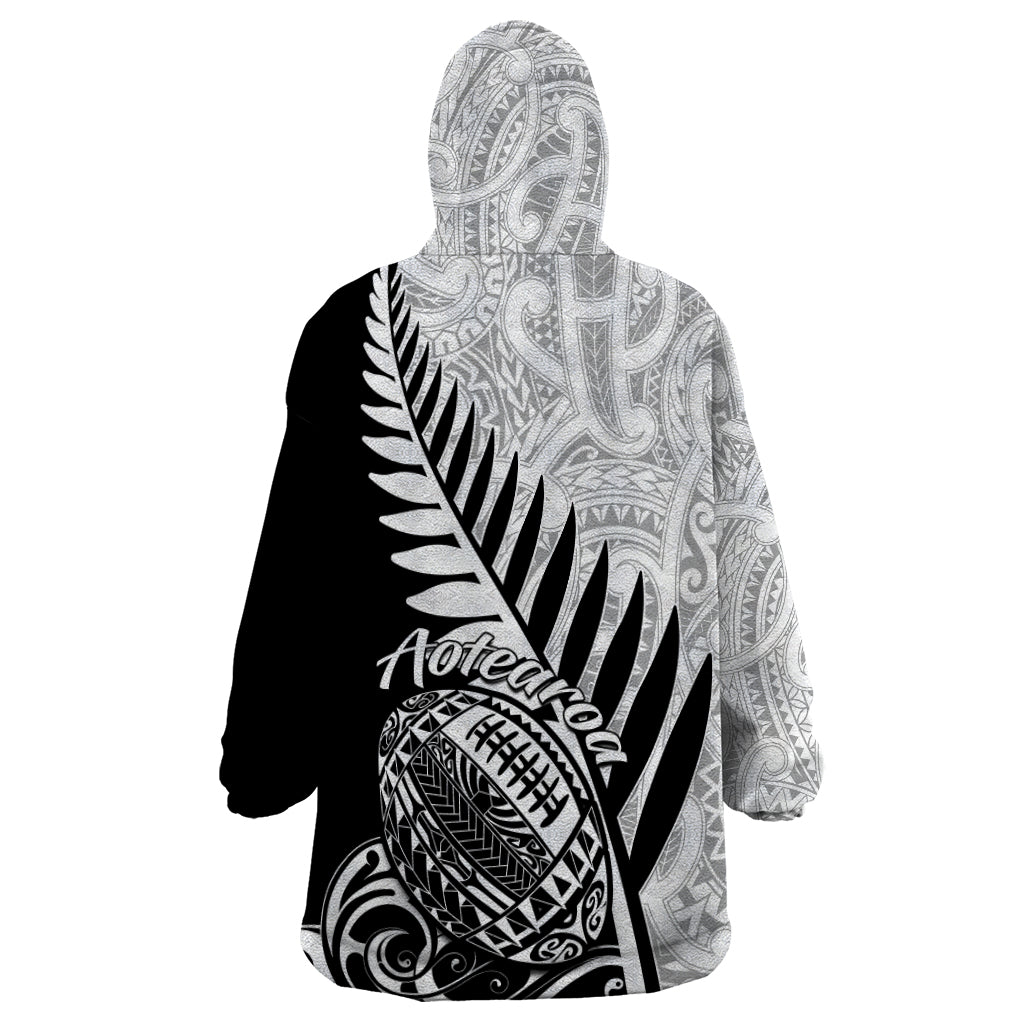 Wearable blanket hoodie with black-and-white Maori tribal print on hooded back panel