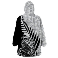 Wearable blanket hoodie with black-and-white Maori tribal print on hooded back panel