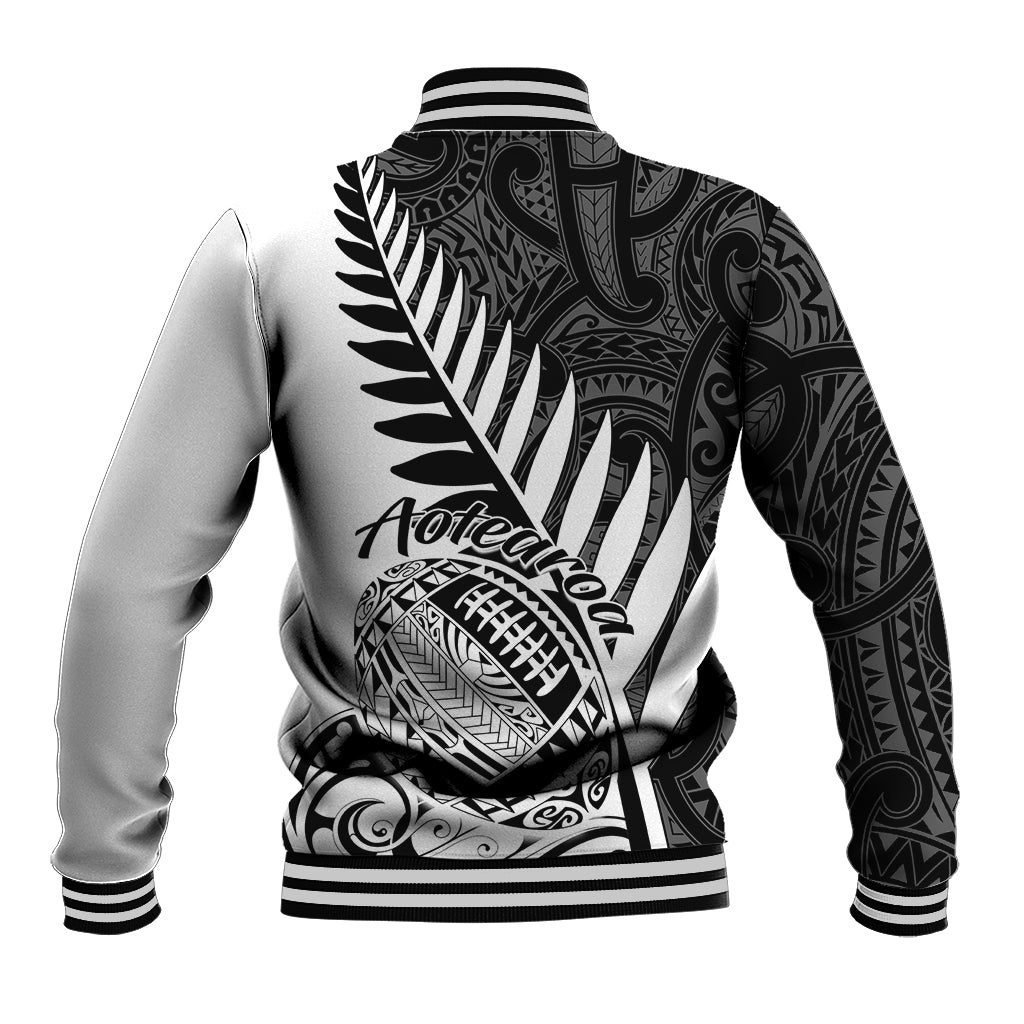 Black-and-white rugby baseball jacket with back fern and Maori pattern graphic
