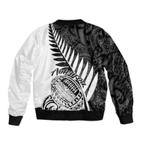 Two-tone black and white rugby bomber jacket with back Maori-style tribal illustration