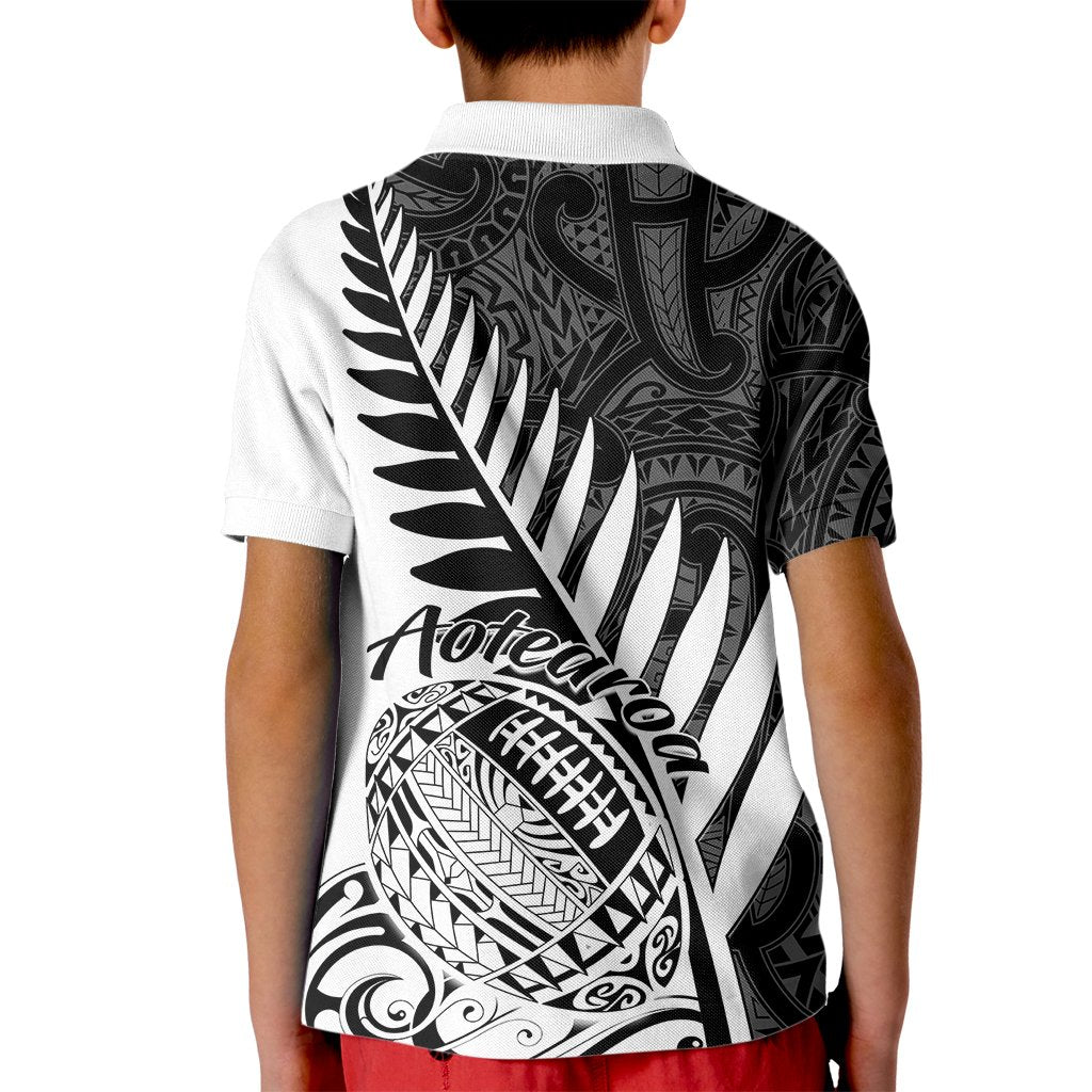 Kids white rugby polo shirt with black back print featuring fern and Aotearoa artwork