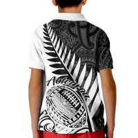 Kids white rugby polo shirt with black back print featuring fern and Aotearoa artwork